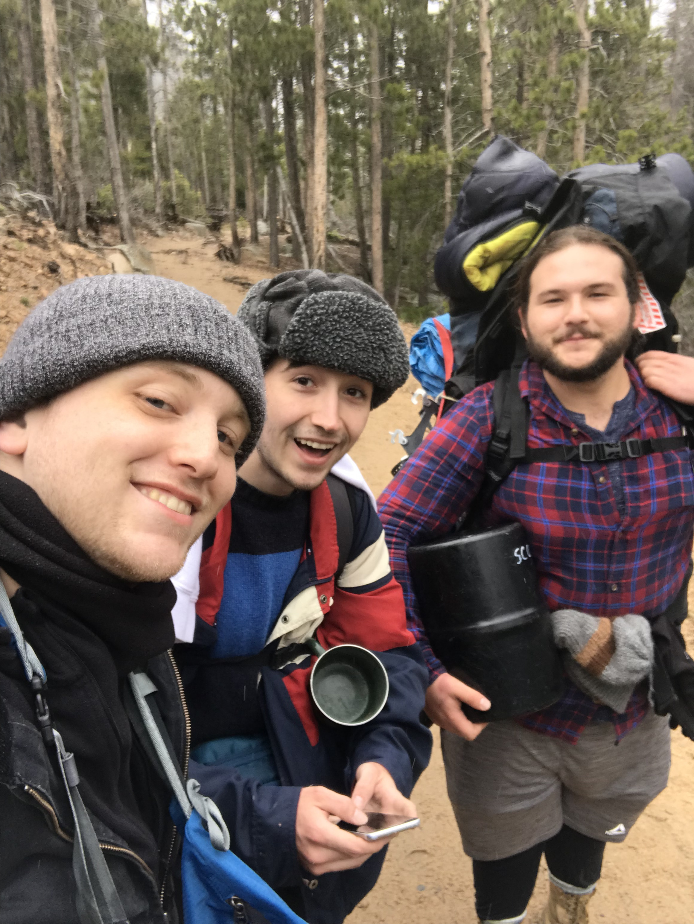 Sam and two friends smiling with hiking gear on the Fern Lake Trail in Rocky Mountain National Park